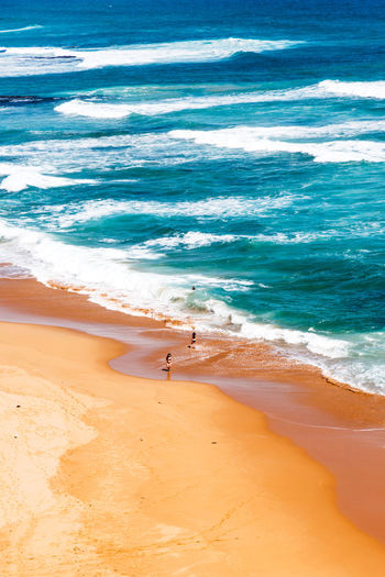 High angle view of people enjoying at beach