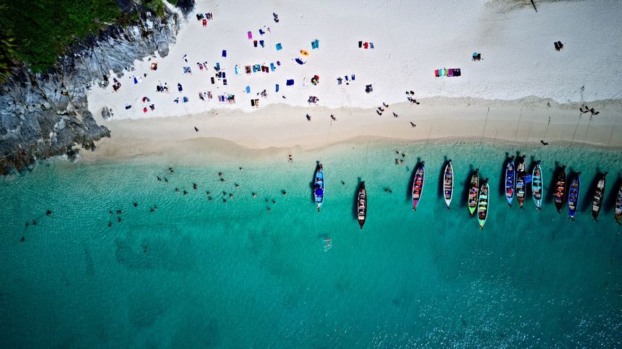 Aerial view of boats and crowd at beach