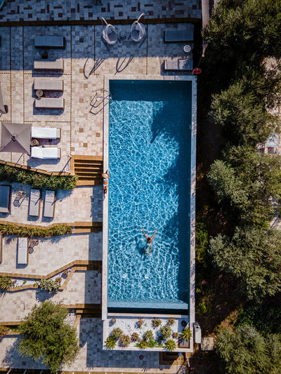 Aerial view of man swimming in swimming pool