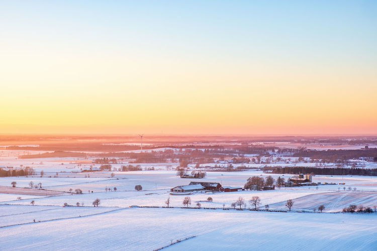 Wintery sunset over a rural landscape with fields and farms