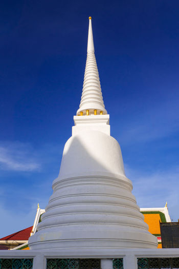 Low angle view of white pagoda against blue sky