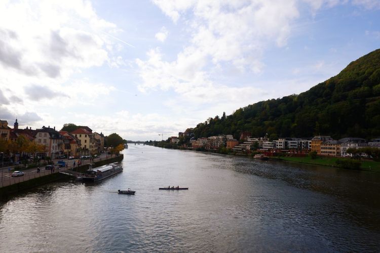 Scenic view of river and city against sky