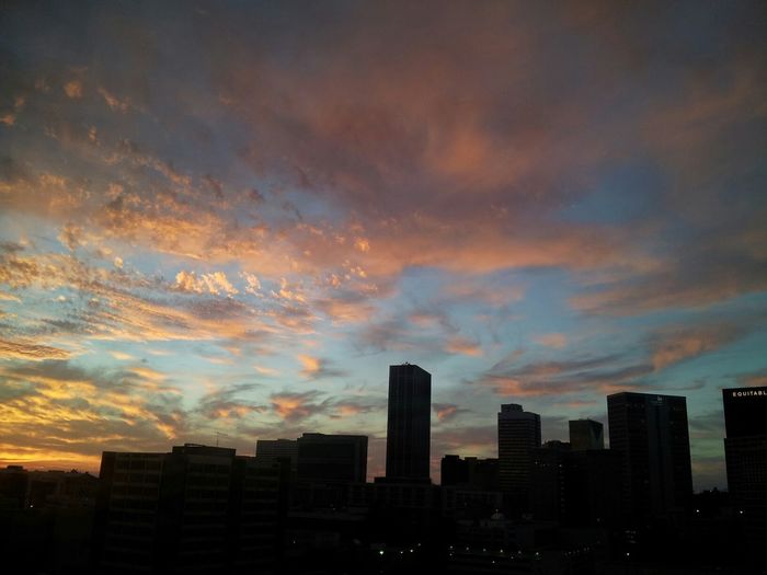 Buildings in city at sunset