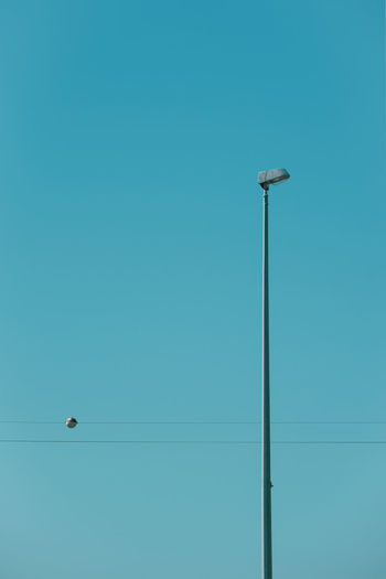 Low angle view of street light against clear blue sky