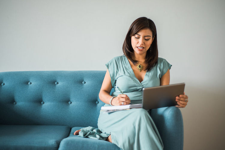 Young woman using laptop while sitting at home