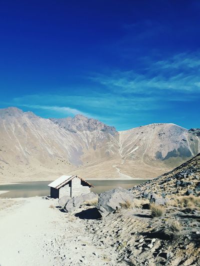 Scenic view of desert against blue sky