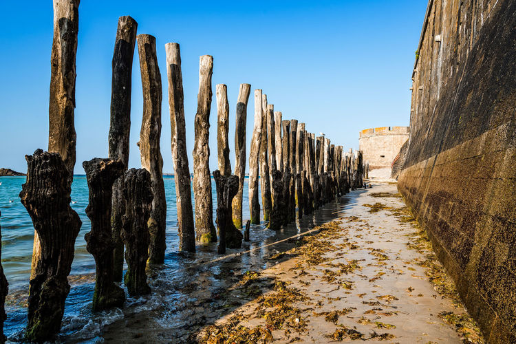 Wooden poles outside saint malo walls. brittany, france, europe