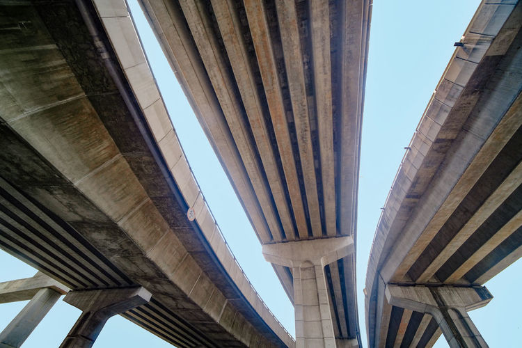 Low angle view of concrete bridges against a clear sky