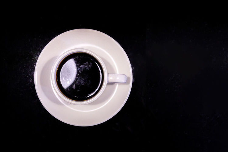 High angle view of coffee over black background