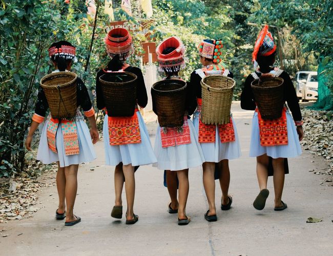 Rear view of females walking on street