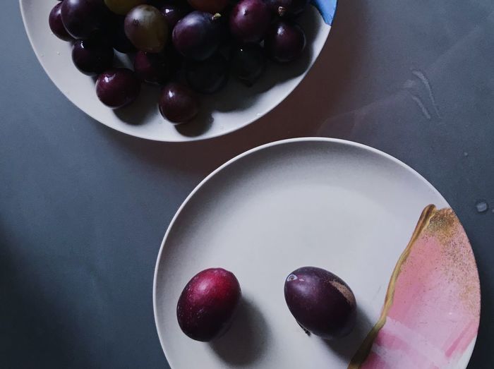 High angle view of grapes in bowl on table