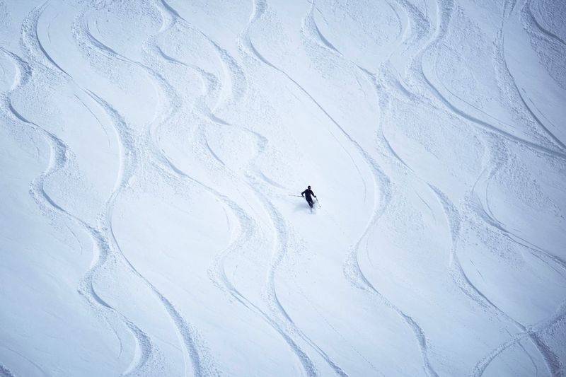 Person skiing on snow covered mountain