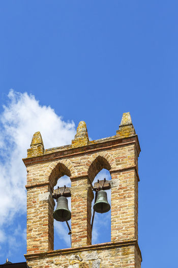 Low angle view of bell tower against clear blue sky