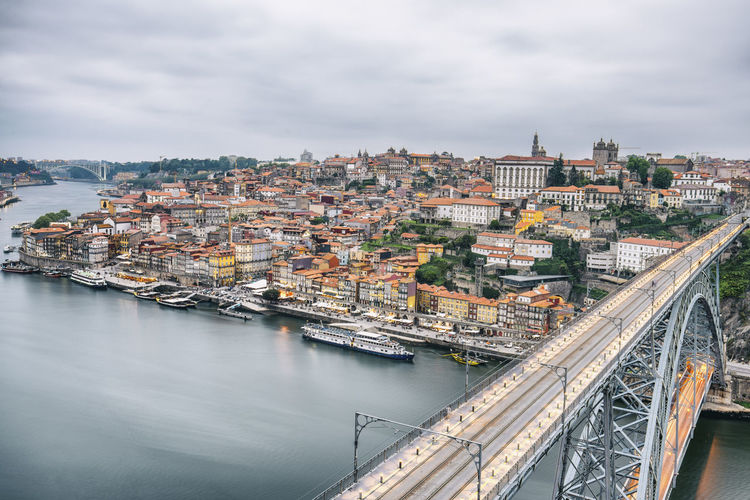 High angle view of a bridge over river amidst buildings in porto