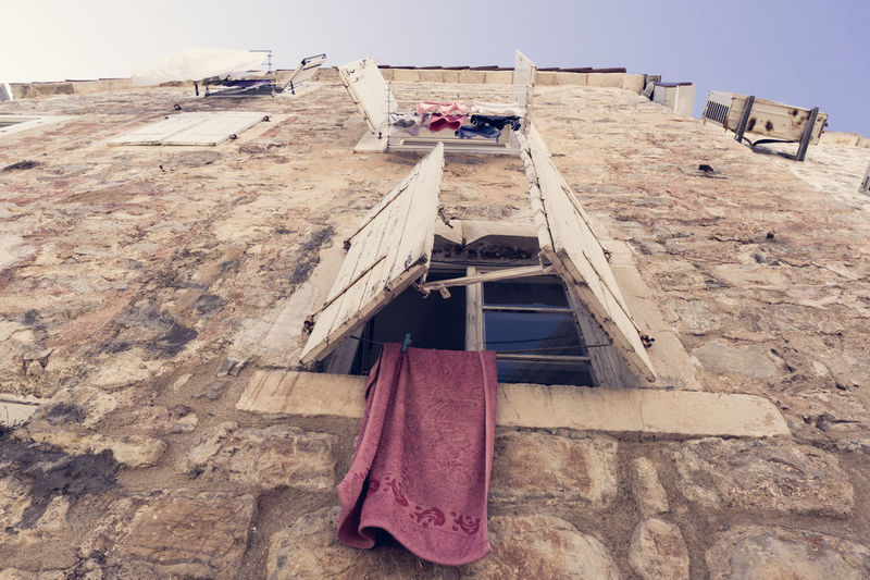 Towel hanging from old building window