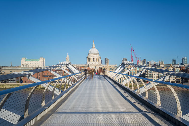 Millennium bridge (london millennium footbridge) over river thames, with st paul's cathedral in background, london, england, united kingdom