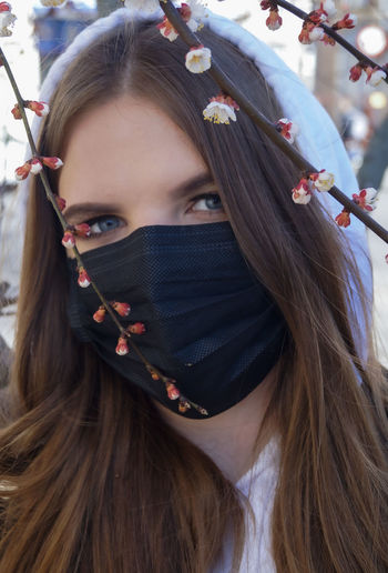 Close-up portrait of young woman wearing mask