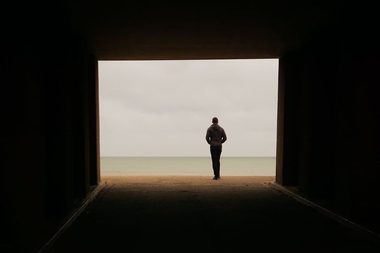 Rear view of silhouette woman walking at beach