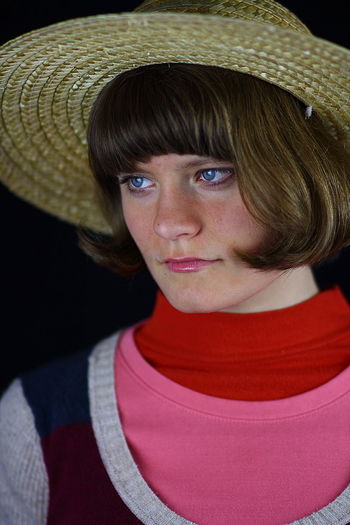 Close-up of young woman wearing hat