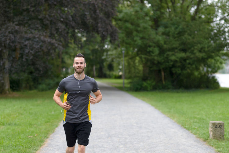 Front view of man jogging in park