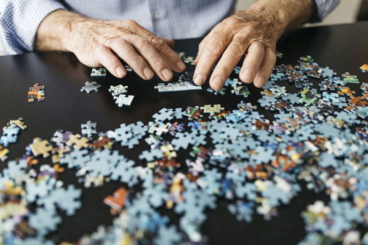 Midsection of man holding jigsaw puzzle