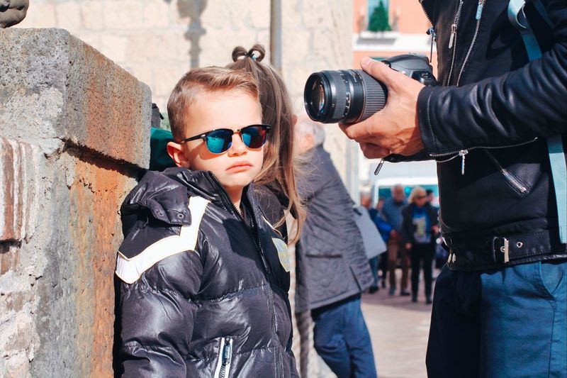 Boy wearing sunglasses standing outdoors