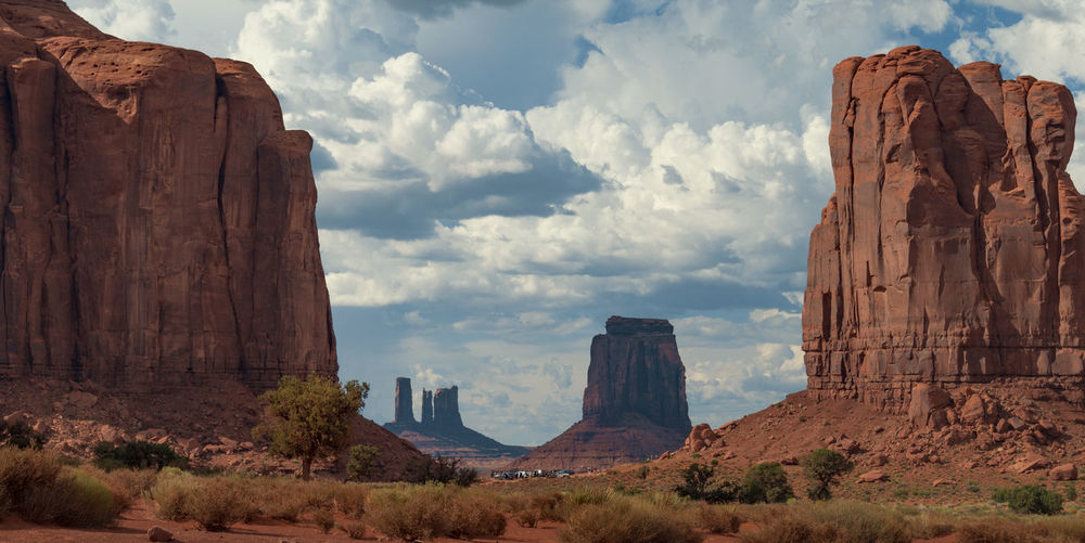 Scenic view of rock formations against cloudy sky