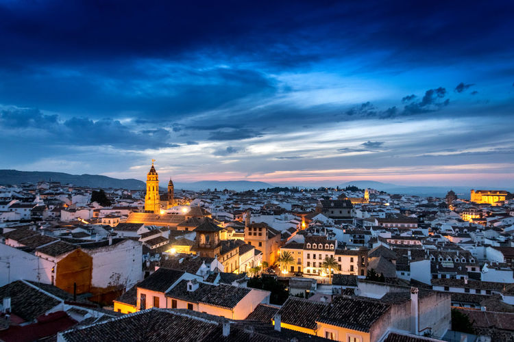 High angle view of city lit up at dusk