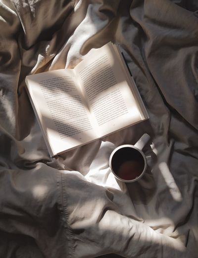 High angle view of coffee cup on bed