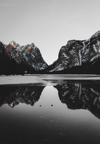 Scenic view of lake and mountains against clear sky