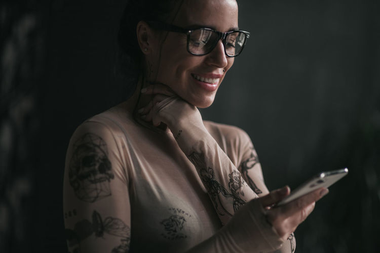 Portrait of smiling man using mobile phone