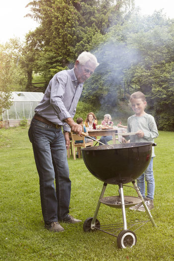Grandfather and granddaughter on a family barbecue