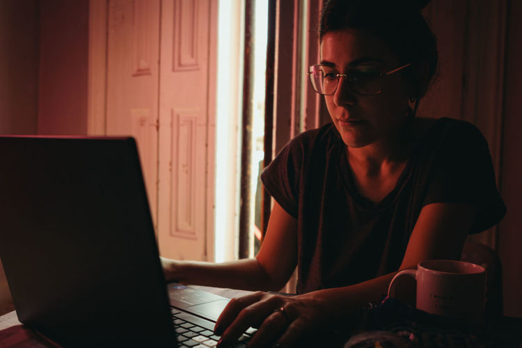 Young man using laptop at table