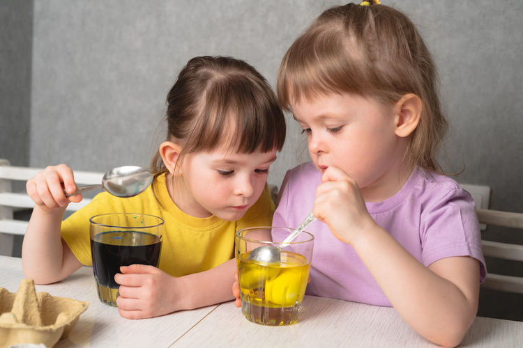 Close-up of girl eating food at home