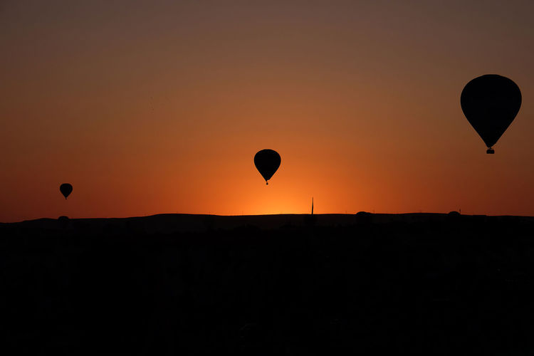 Silhouette of hot air balloon against sky during sunset, goreme