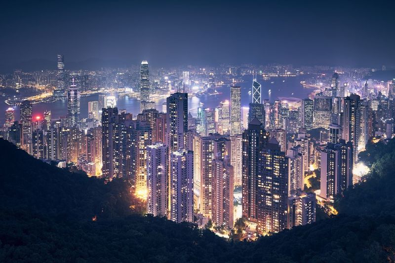 Aerial view of illuminated buildings in city at night