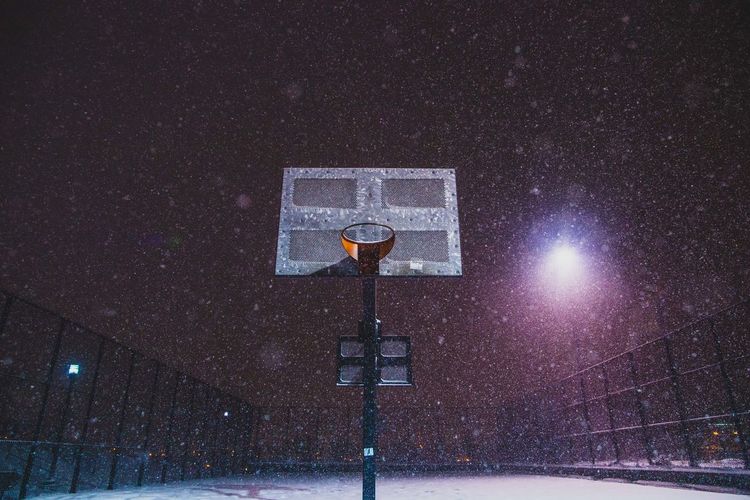 Low angle view of basketball court during snowfall