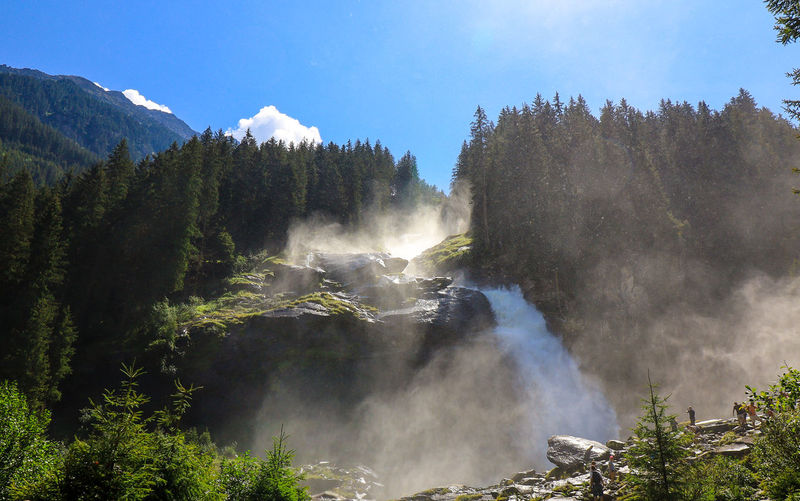 Panoramic view of waterfall in forest against sky