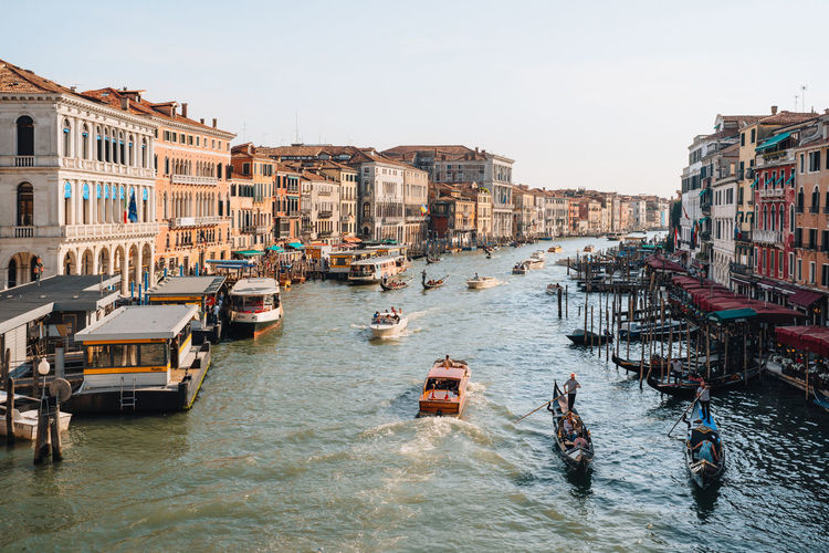 Boats, gondolas and water taxis navigating through grand canal in venice, italy.