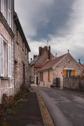 Street amidst buildings against sky