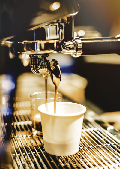 Close-up of pouring coffee in cup