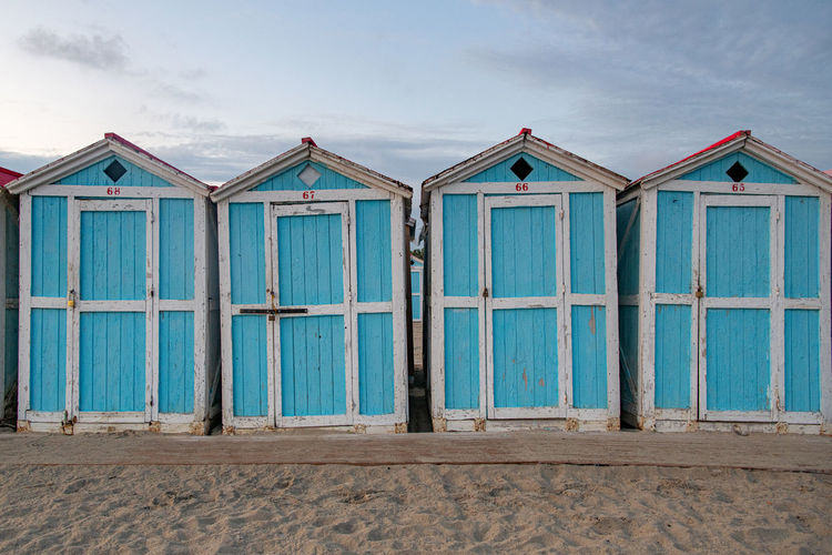 Little blue houses on the beach. sunset on the mediterranean coast. old cracked paint