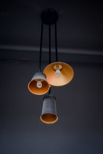 Low angle view of electric lamp hanging from ceiling