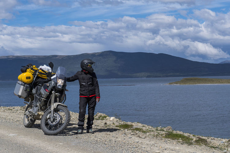 Woman standing next to her off road touring motorbike in argentina