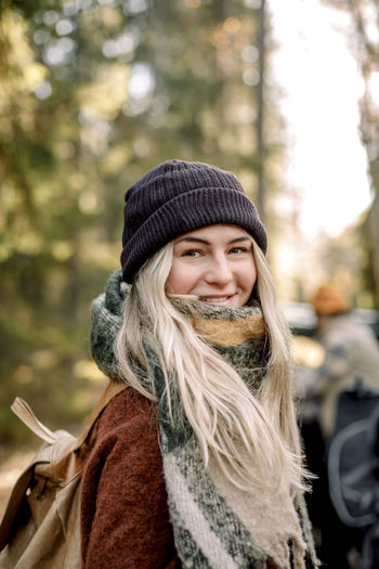 Portrait of smiling blond woman wearing knit hat