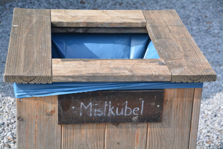 High angle view of wooden garbage can on street