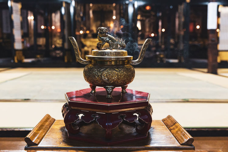Close-up of incense pot at a temple in japan