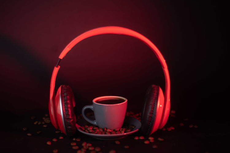 Close-up of coffee cup on table against black background