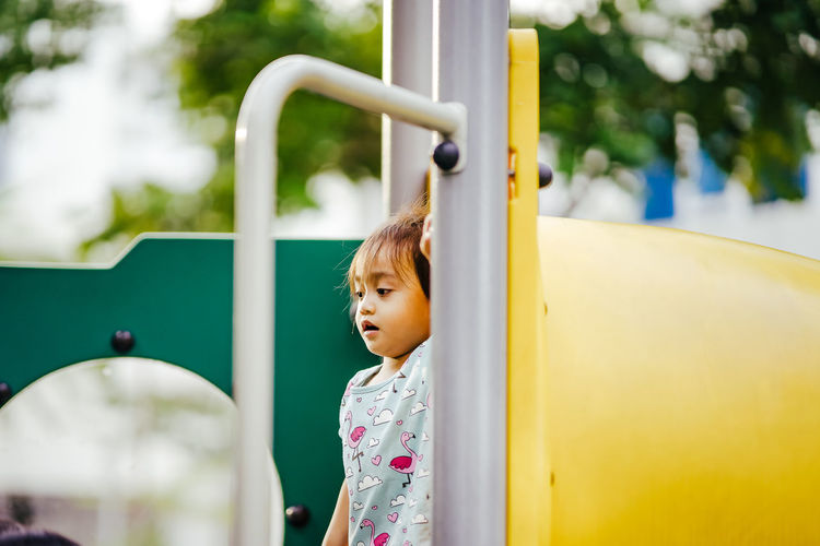 Girl standing on slide