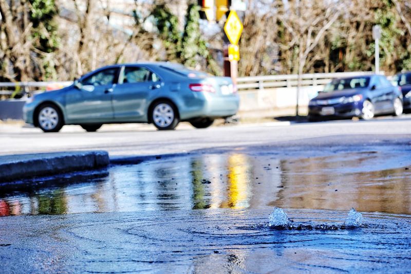 Reflection of cars on wet road in rainy season
